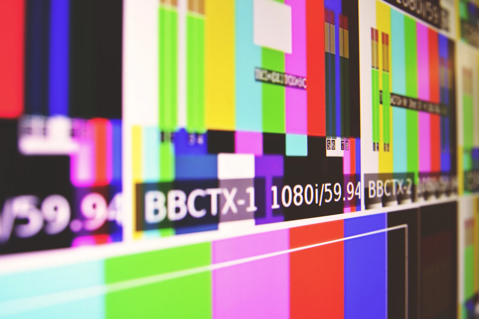 Close-up of a display showing broadcast colour bars with a 1080i/59.94 format label
